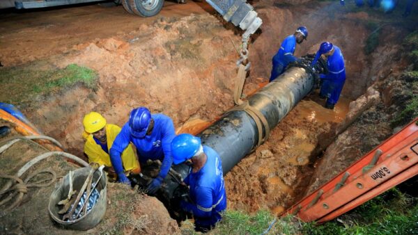 sewage Workers repair pipes in Salvador. Photo: Joa Souza/Shutterstock
